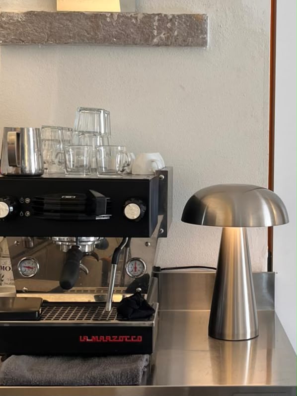 La Marzocco espresso machine and sculptural table lamp at NŌMA
