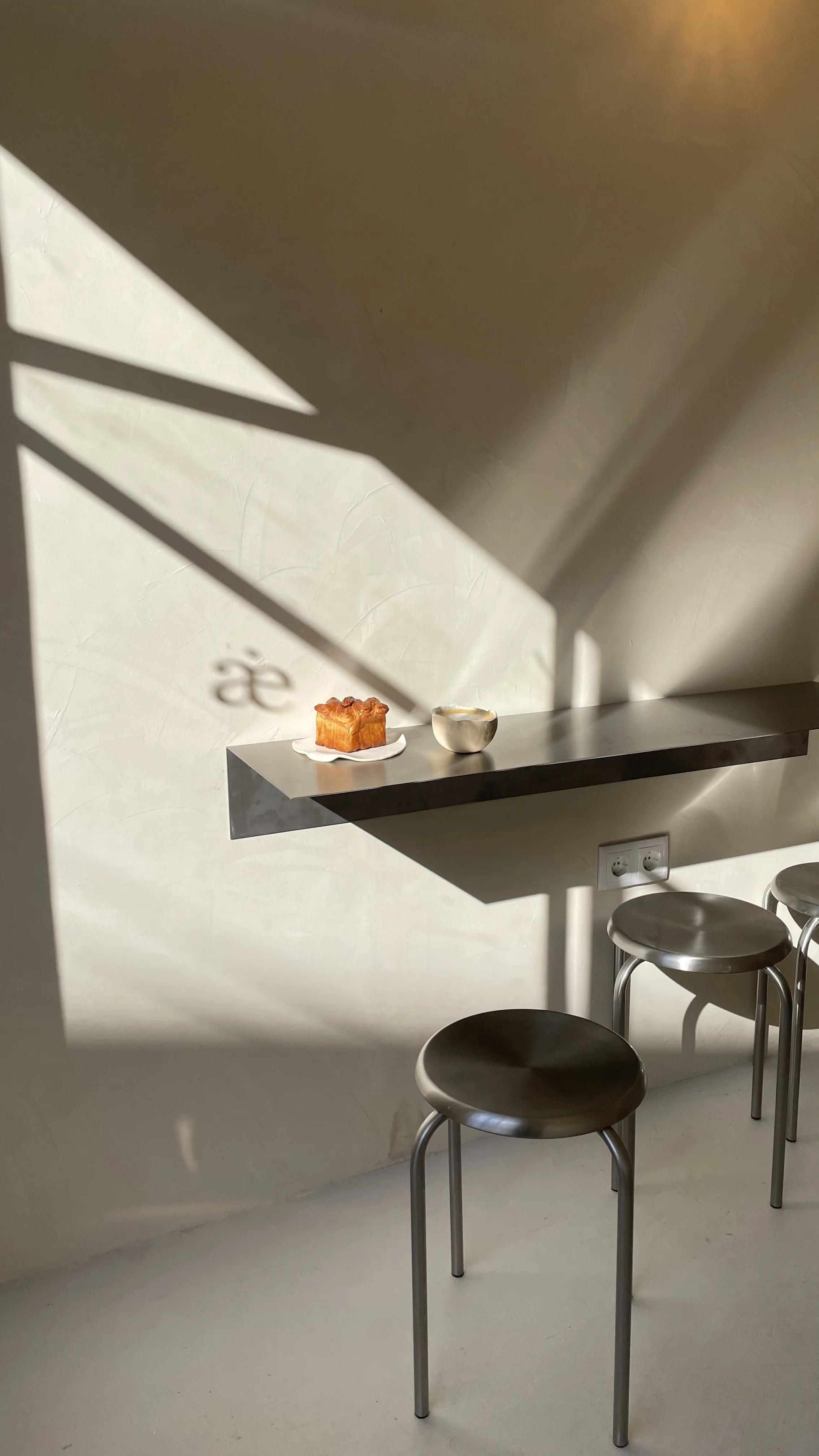 The Lisbon pilot location — light casting an æ shadow across the wall