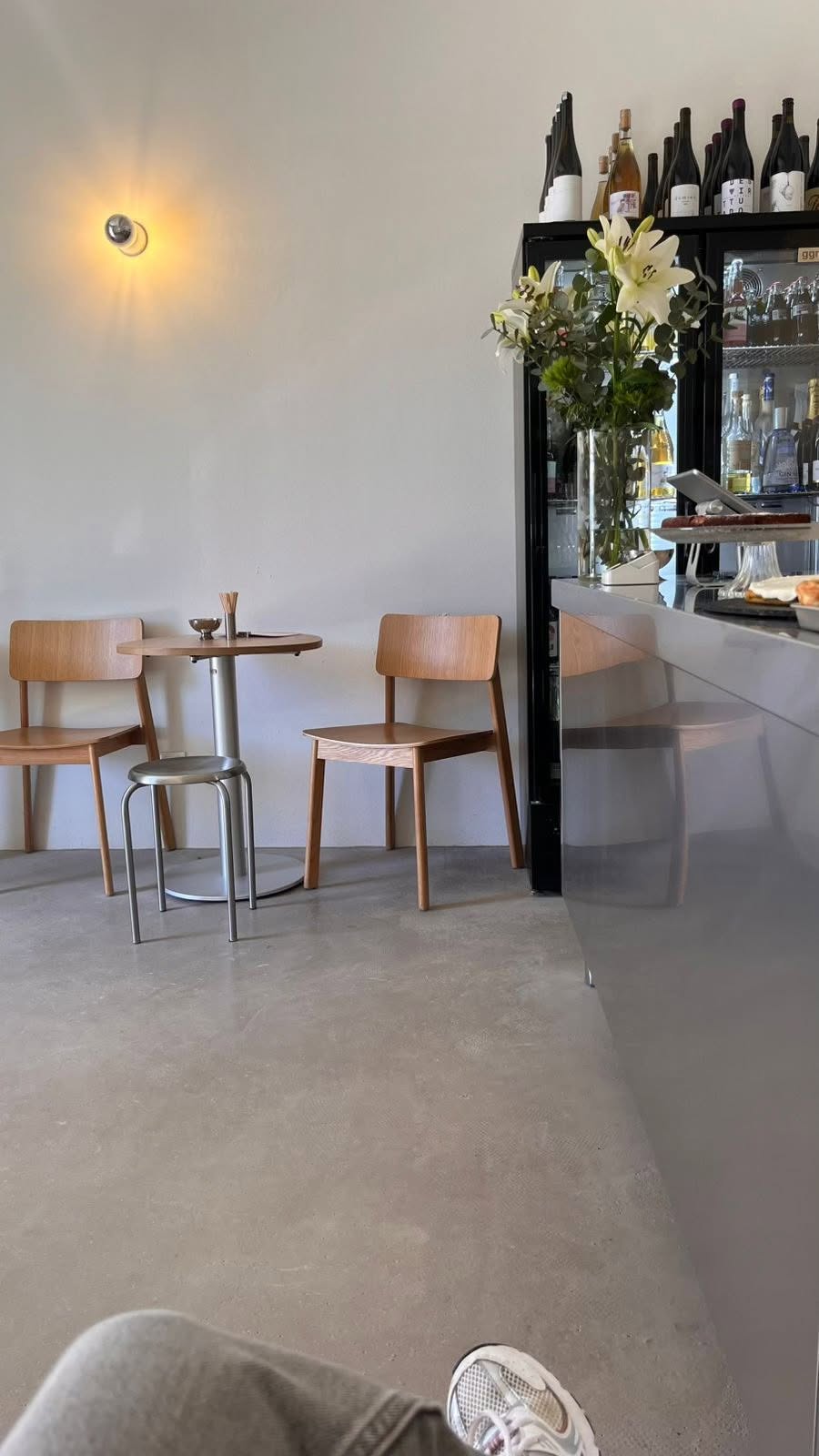 NŌMA café interior with oak chairs and a minimalist bar