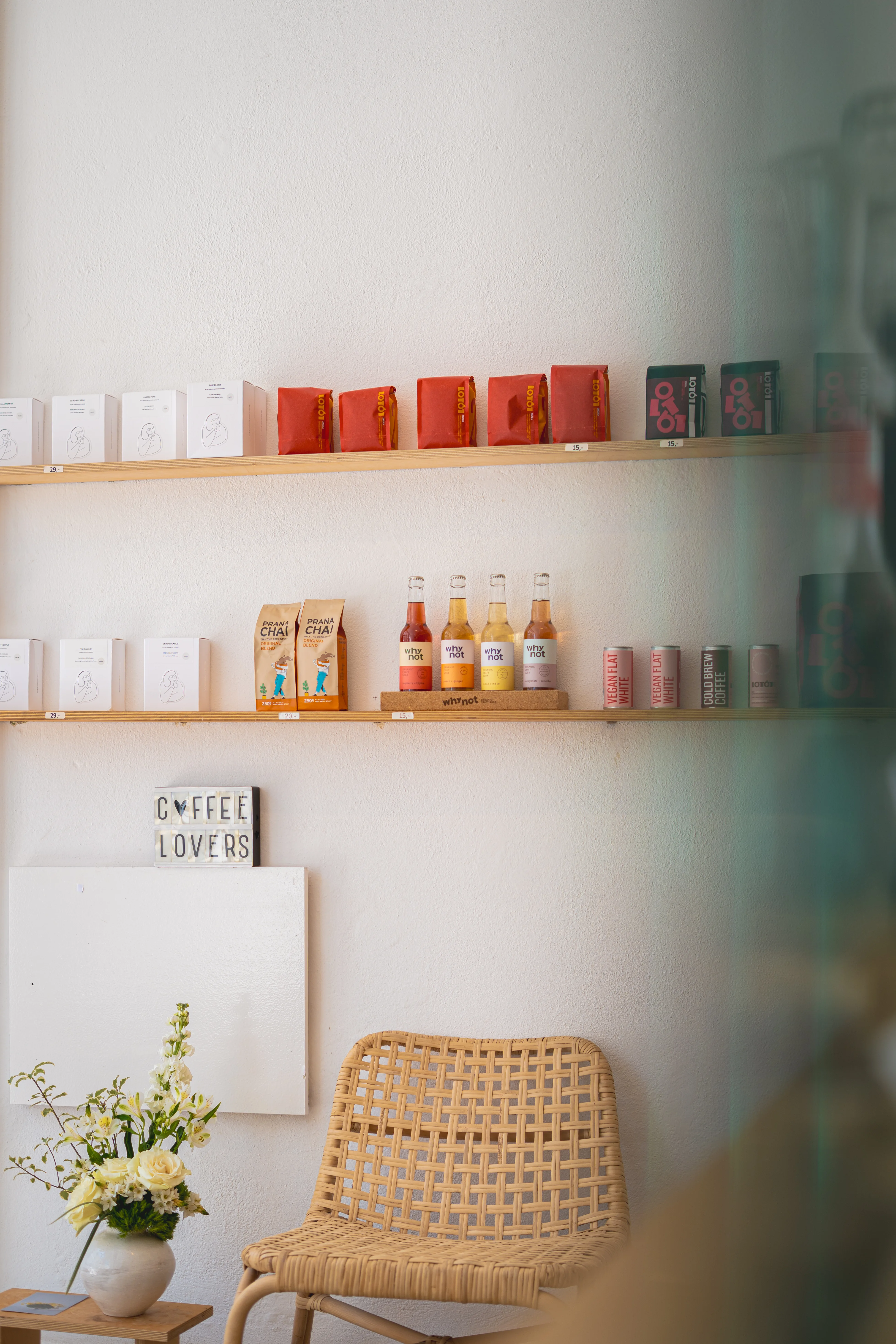 THE TABLE in Tavira — specialty coffee shelves, Prana Chai and a woven chair